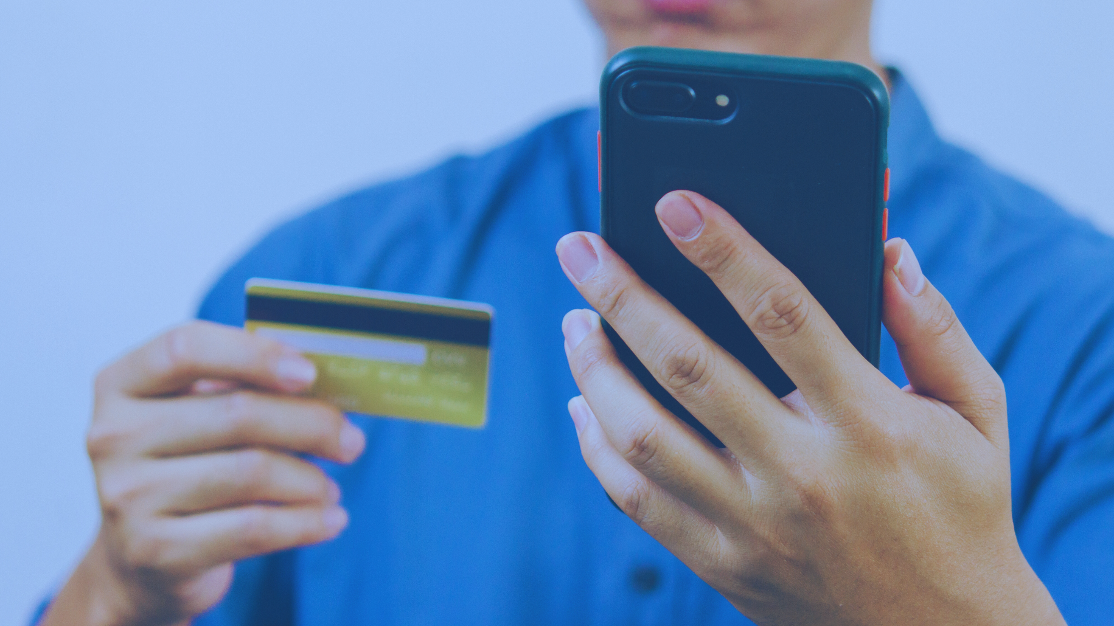 Man charging merchandise from his mobile phone